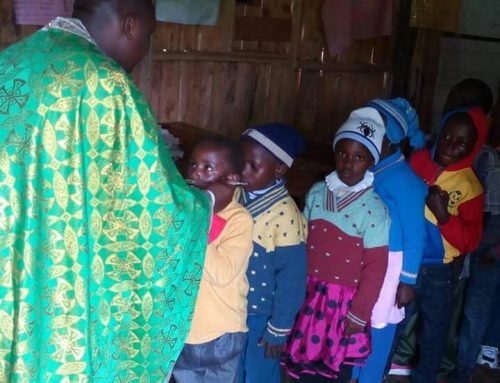 Fr Constantinos giving Holy Communion to orphans in St Irene Orthodox mission center and Orphanage