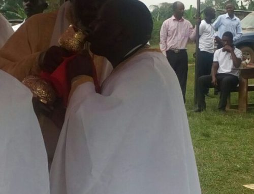 Fr Constantinos receiving Holy Communion from His Eminence Jonah Lwanga of Uganda